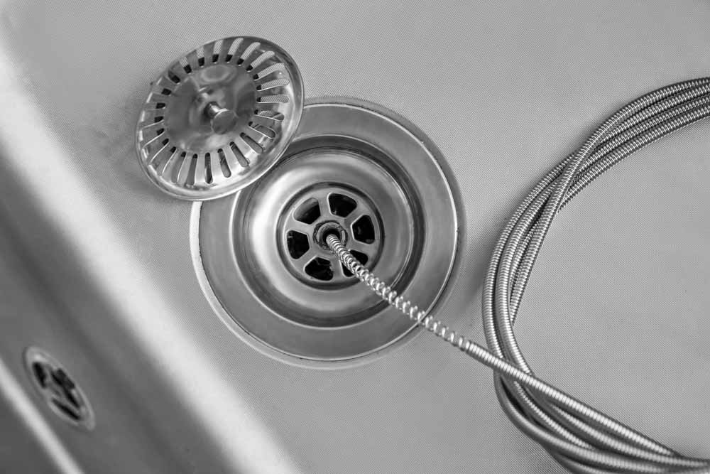 E.R technician unclogging a kitchen drain